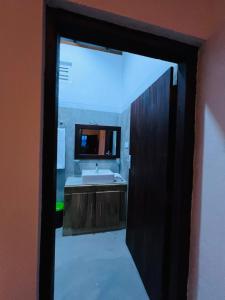 a bathroom with a sink and a mirror at Jesoloresort Arugambay in Arugam Bay