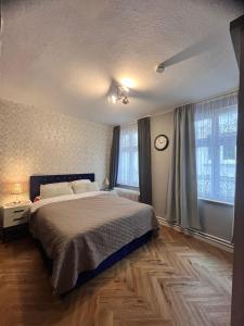 a bedroom with a large bed and two windows at EVIA Hotel restaurant in Recklinghausen