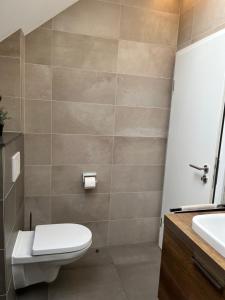 a bathroom with a toilet and a sink at Hotel Auberge Rustique in Beaufort +69 photos