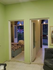a living room with two doors leading to a bedroom at old house ureki in Ureki