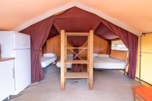 a room with a bed and a ladder in a tent at Camping Cambrils Caban in Cambrils +66 photos