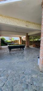 a pool table sitting on a patio under a building at old house ureki in Ureki +1 photo