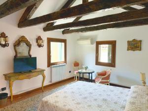 a bedroom with a large bed and a table at Ca' Pierre in Venice