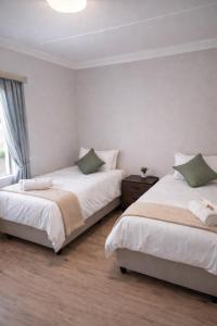 two beds sitting next to each other in a bedroom at Langpad Self Catering in Frankfort