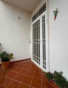 an open door of a house with a patio at Casa Glicine in Sperlonga