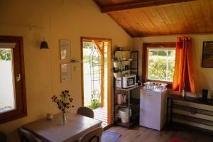 a kitchen with a white refrigerator and a table at Szőlőskert Vendégház in Baj +52 photos