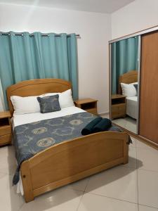 a bedroom with a bed and a large mirror at Casa Amélia in Cidade Velha