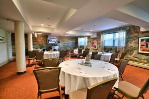 a dining room with tables and chairs in a room at The Centennial Hotel in Concord