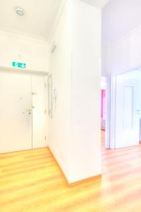 an empty room with white walls and wood floors at La casetta al mercato in Civitavecchia +27 photos