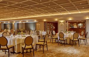 a banquet room with white tables and chairs at Killarney Avenue in Killarney