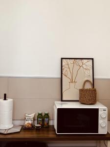 a microwave on a table with a picture on top of it at Dimora da Adele in Termoli