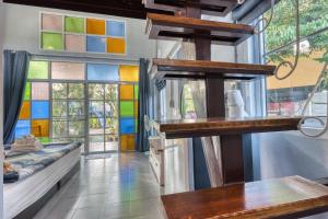 a room with stained glass windows and a table at Na Na Doo Homestay in Chiang Rai