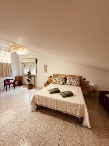 a bedroom with a large bed and a room with a table at Dimora da Adele in Termoli