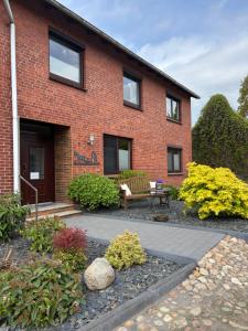 a brick house with a bench in front of it at Ferienwohnung Bohlen in Wehden