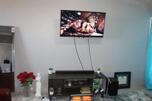 a flat screen tv hanging on a wall in a living room at Penthouse in Bloemfontein +20 photos
