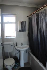 a bathroom with a toilet and a sink at Penthouse in Bloemfontein