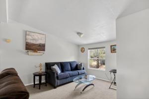 a living room with a blue couch and a table at Tehachapi 12-Guest Group Escape home in Tehachapi +25 photos