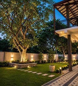 a garden at night with lights on the grass at Araliya Villa in Tangalle