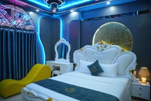 a bedroom with a white bed and a yellow chair at Haven Hotel in Ho Chi Minh City
