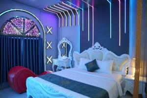 a bedroom with a white bed and purple walls at Haven Hotel in Ho Chi Minh City