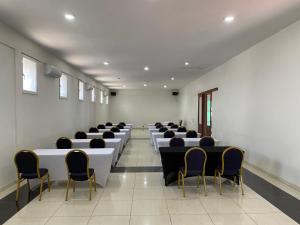 a large room with rows of tables and chairs at Hotel Monte Verde in Beira +18 photos