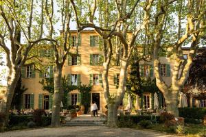 a building with trees in front of it at Hôtel - Restaurant & Spa La Magdeleine - Mathias Dandine in Gémenos