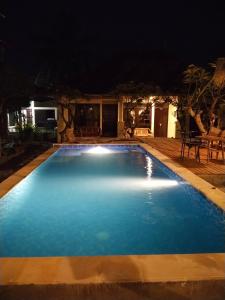 a large swimming pool at night at Puri Mandhara Lovina in Lovina