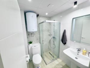 a bathroom with a shower and a toilet and a sink at The Spot Apartments in Ohrid