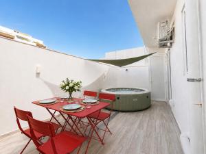 a room with a table and chairs and a hot tub at Large 3-Bedroom with Jacuzzi near St Julians in Is-Swieqi
