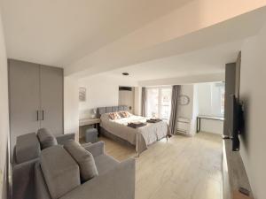 a living room with a couch and a bed at The Spot Apartments in Ohrid