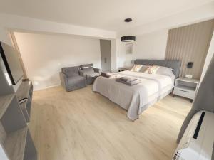 a bedroom with a bed and a couch at The Spot Apartments in Ohrid +7 photos