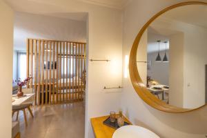 a bathroom with a round mirror and a sink at Cavaliere Seafront House - Klio in Sami