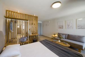 a bedroom with a large bed and a couch at Cavaliere Seafront House - Klio in Sami