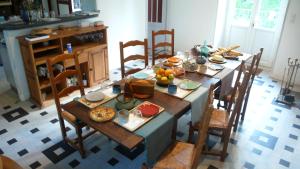 a table with food on it in a kitchen at Au Bois de la Grave in Luzech