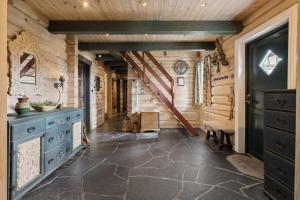 a hallway in a log cabin with a blue dresser and stairs at Orreleiken in Åmot