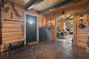 a log home hallway with a door and a living room at Orreleiken in Åmot