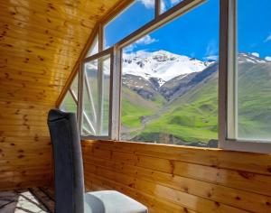 a window in a room with a view of a mountain at Xinaliq Khinalig İzzet's Riverside Home Stay in Xınalıq