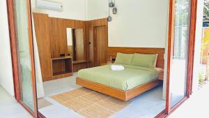 a bedroom with a bed in a room at Encore by Serenity in Hampāpura