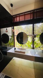 a bathroom with a sink and a large window at Encore by Serenity in Hampāpura