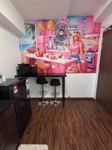 a room with a barbie kitchen with a painting at K Avenue by Stay & Unwind Suites in Donggongon