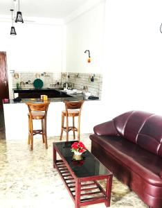 a living room with a couch and a table at Elysian Riverside in Weligama