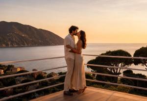 a bride and groom kissing in front of the ocean at Counting Stars - Private Luxury Retreat for Two in Recco