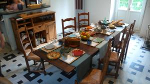 a table with food on it in a kitchen at Au Bois de la Grave in Luzech +22 photos