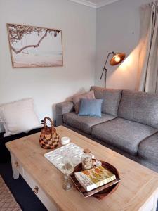 a living room with a couch and a coffee table at Beach & Forest Stay in Port Arthur