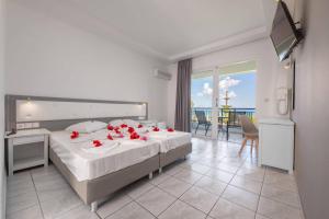 a bedroom with a bed with red roses on it at Stella Maris in Kos +82 photos