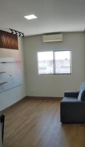 a living room with a couch and a window at Ótima localização in Imperatriz