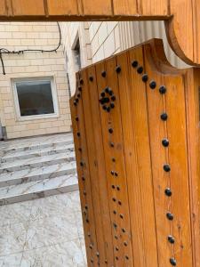 a wooden door with beads on it with a window at Hostel MJ ,Sidi kbir in Zarzis