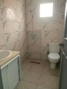 a bathroom with a toilet and a sink at Hostel MJ ,Sidi kbir in Zarzis