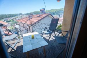 a view of a balcony with chairs and a table at Luxury Villa Medusa Temple in Kruševo