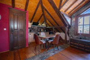 a kitchen with a table and chairs in a room at Luxury Villa Medusa Temple in Kruševo